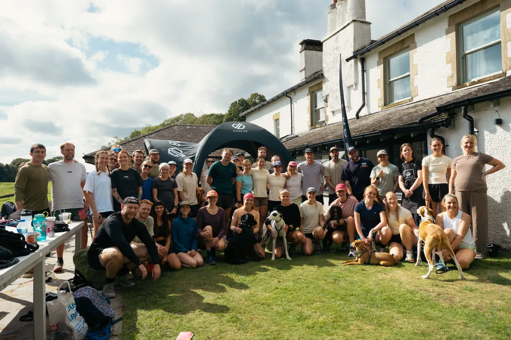 The full group gathered outside a Lake District farmhouse under the Dare2B arch at 4ZERO x Dare2B.